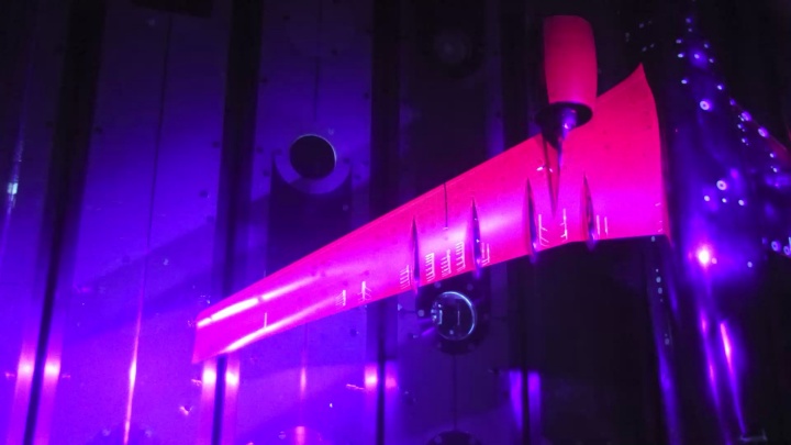 Lower side of the model coated with PSP paint illuminated by UV light in the wind tunnel
